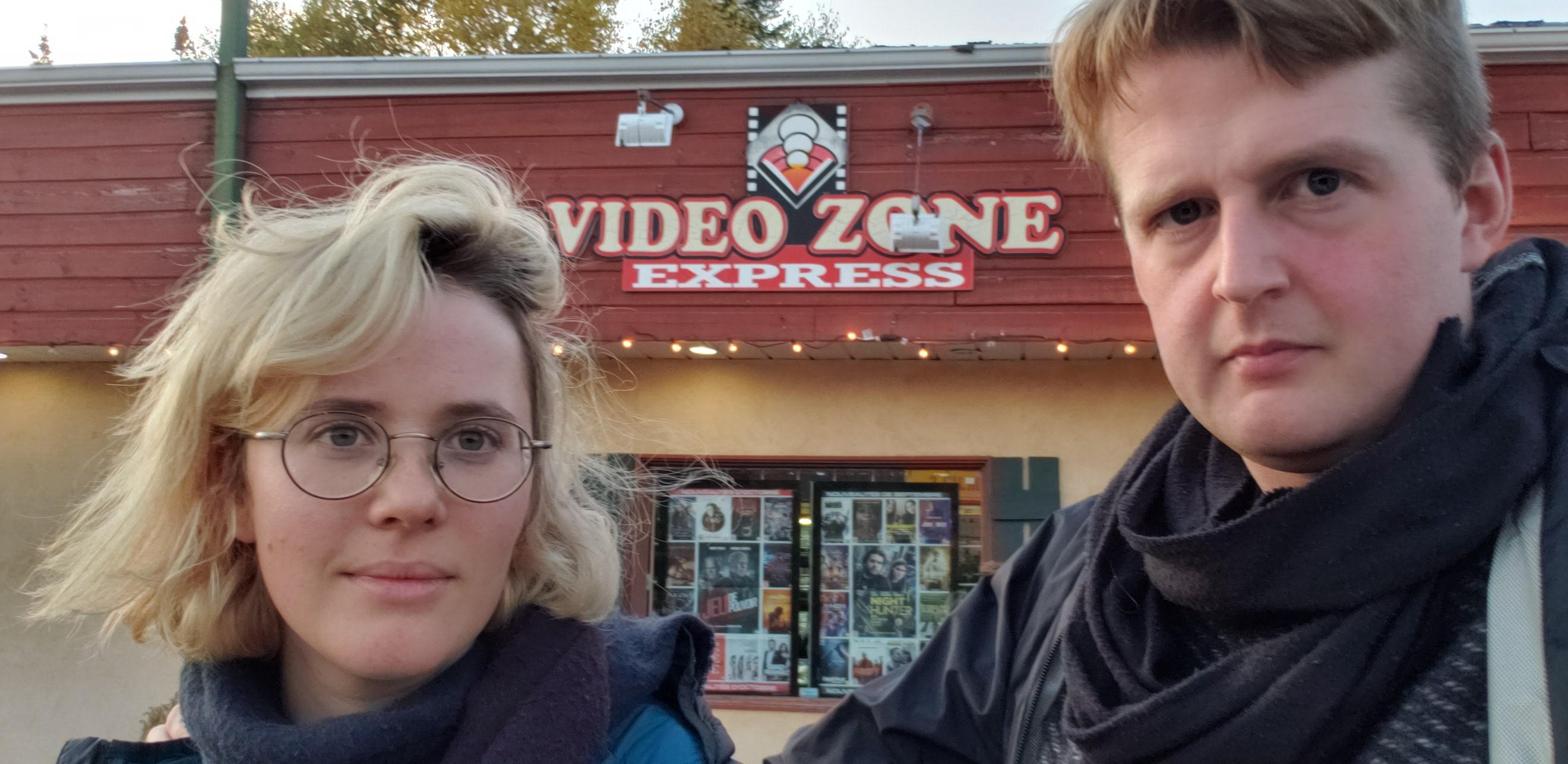 The members of Serious Computer Group, Nina Bouchard and Evan Montpellier, standing in front of a store called Video Zone.